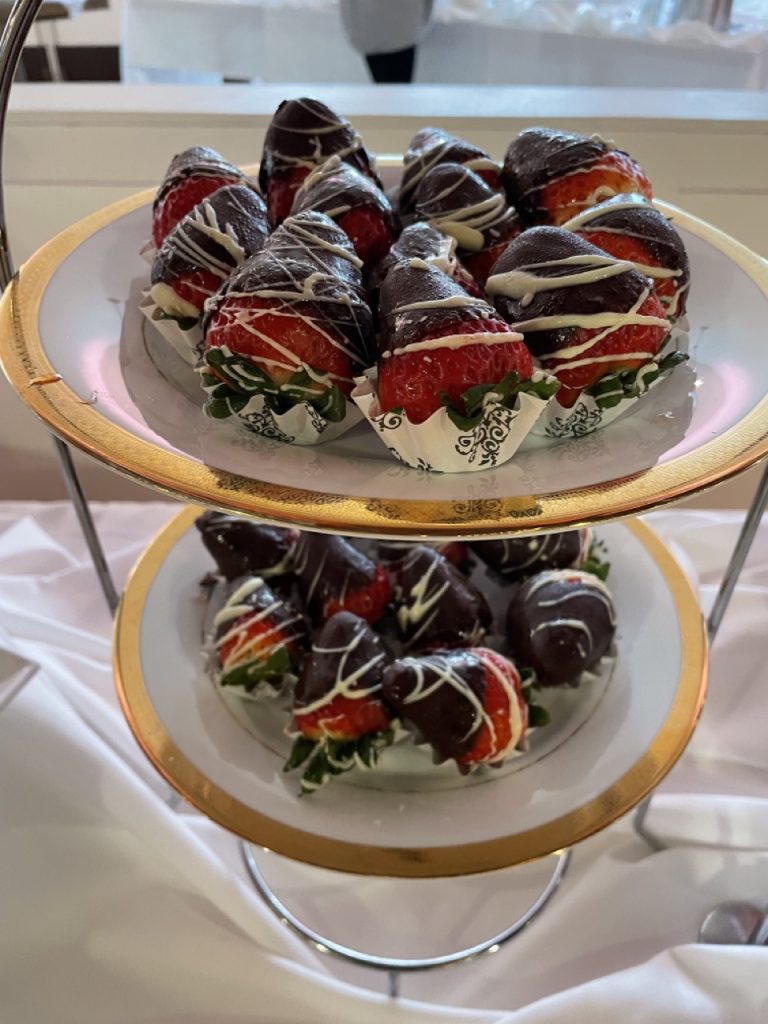 Milk chocolate covered strawberries with a white chocolate drizzle by Arista catering