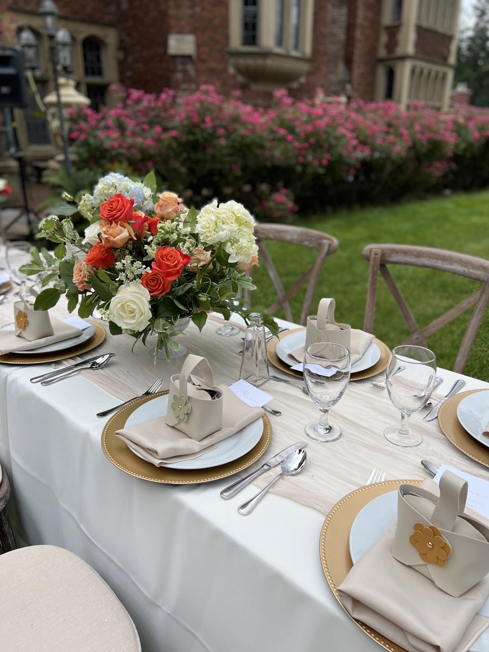 Wedding table with rose center piece and napkins on plate